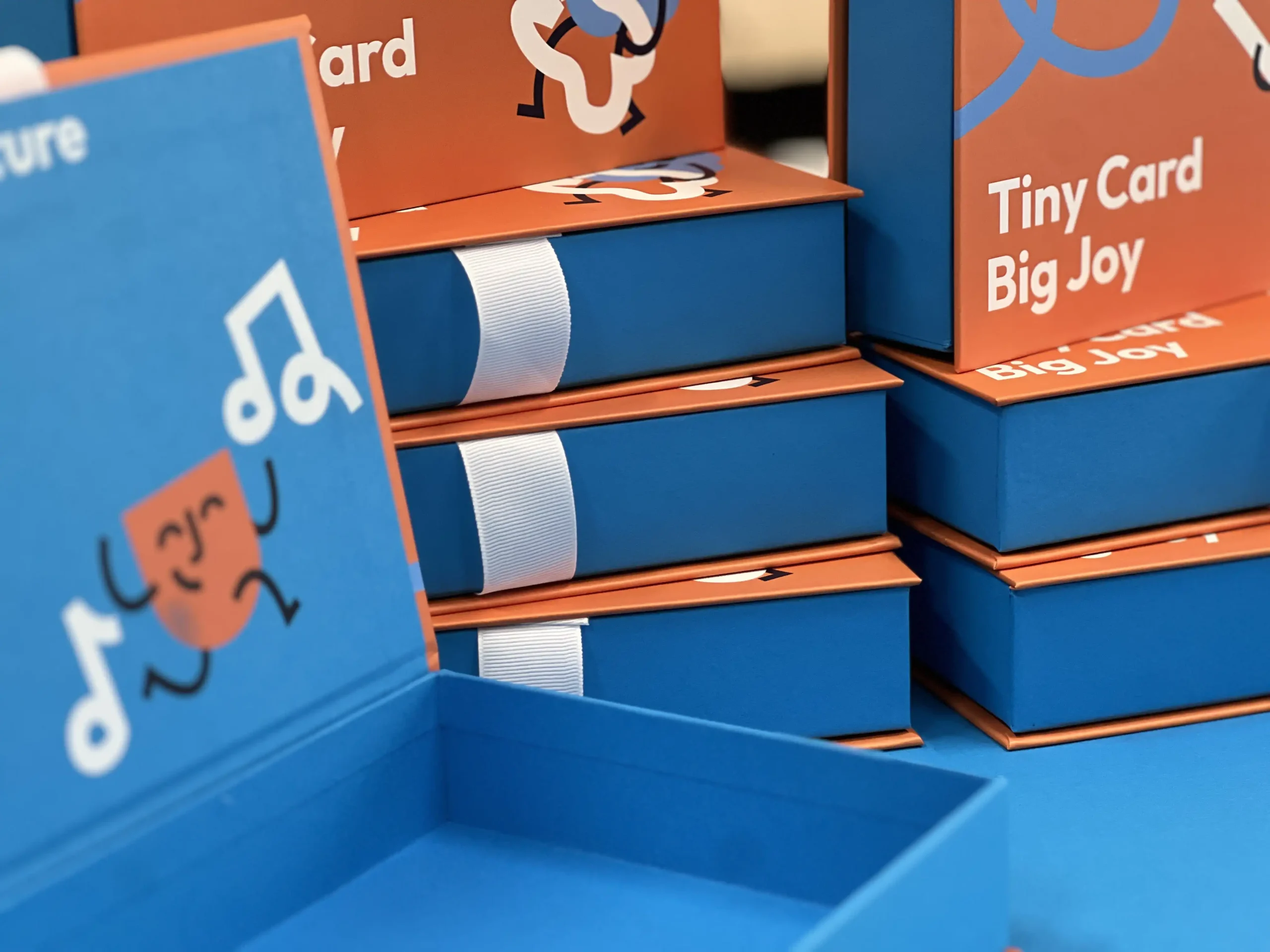 Production of durable packaging for gojoy playing cards. Featuring sturdy cardboard, functional ribbon closure, full-color and silk screen printing.