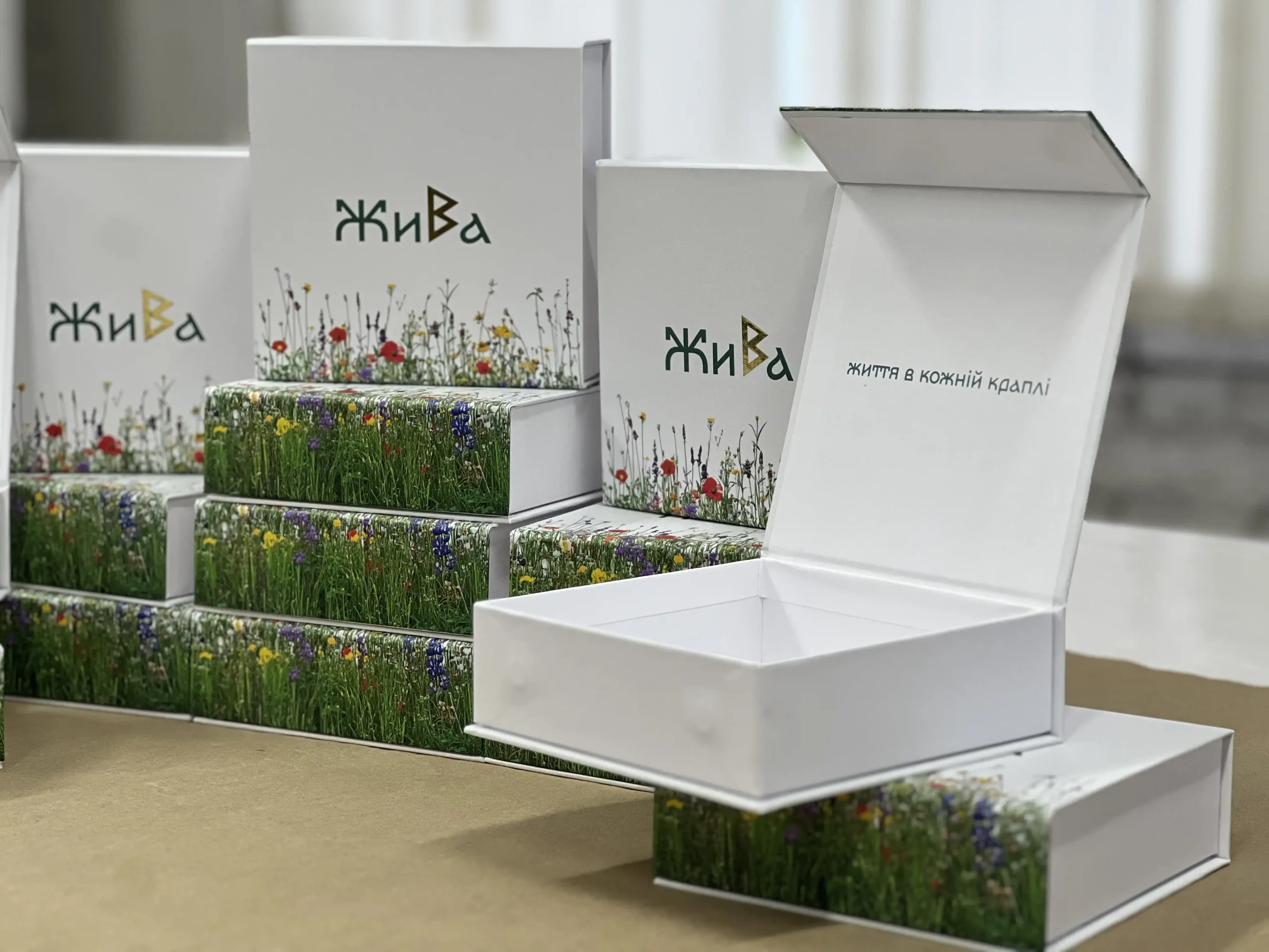 Production of secure packaging for Zhyva vials. Featuring durable cardboard, floral print, gold foil stamping, and protective matte lamination.